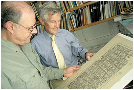 Ian Graham (right), Director of Harvard's Maya Corpus Project, shows film director David Lebrun his drawing of a Maya inscription.